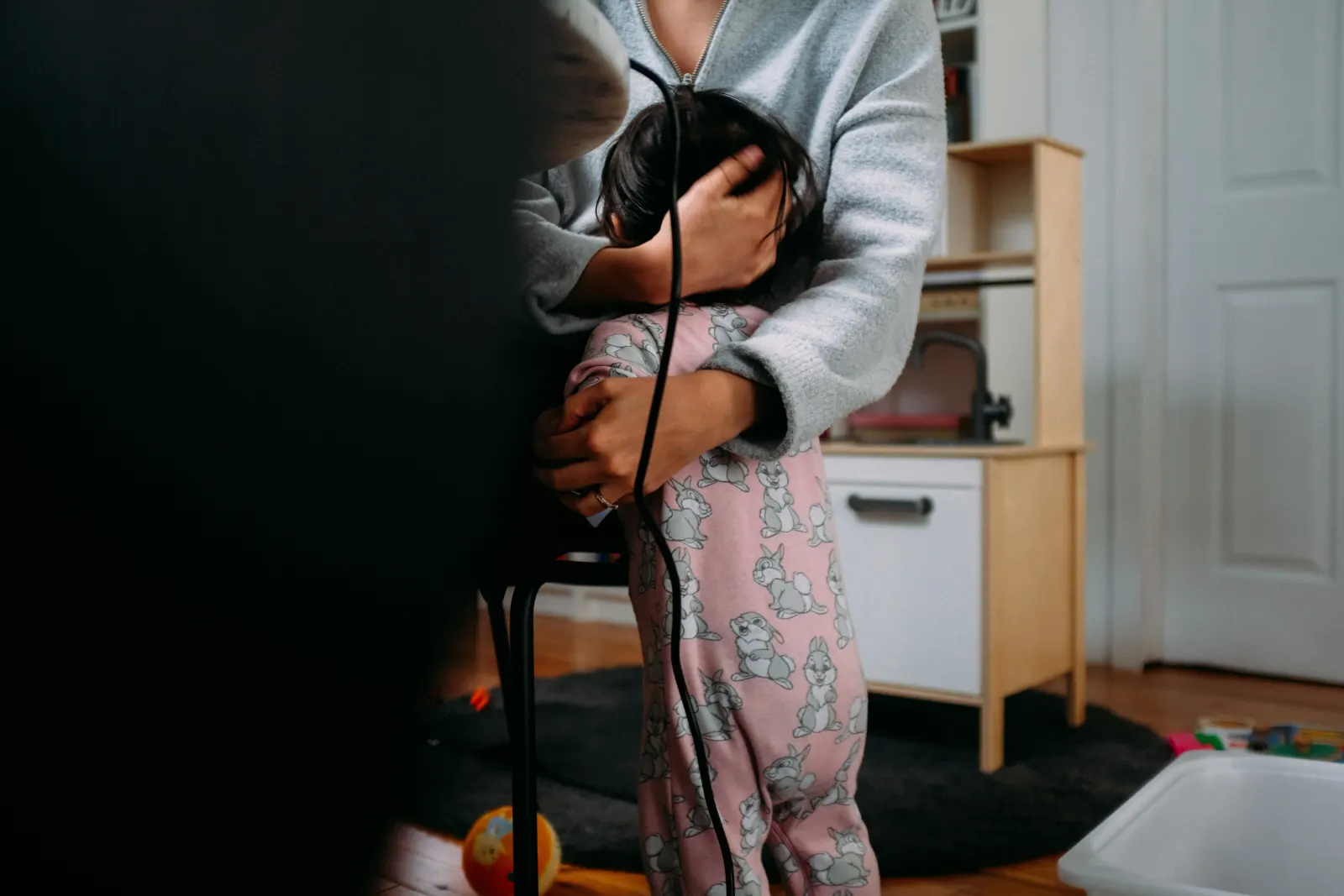 Teen hugging a kid