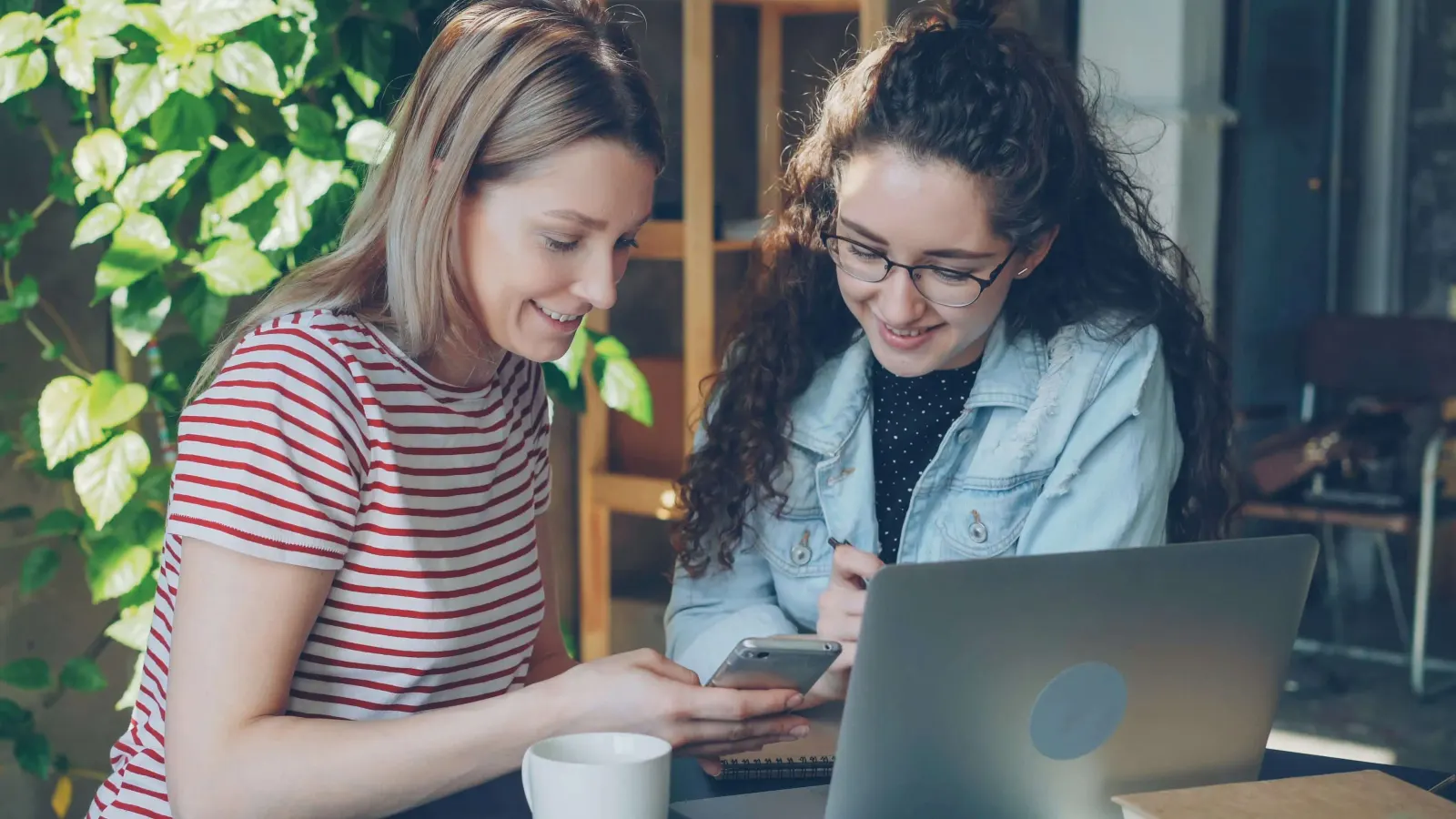 Two girls using a phone