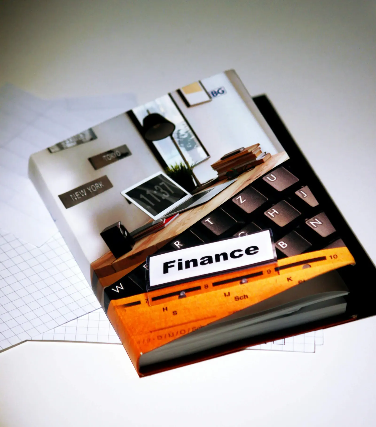 Collage-style book cover with a Finance tab over an office and keyboard scene