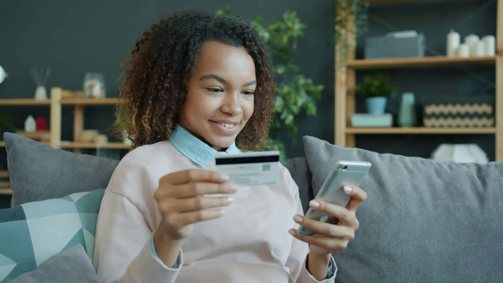 Teen using a debit card and banking app