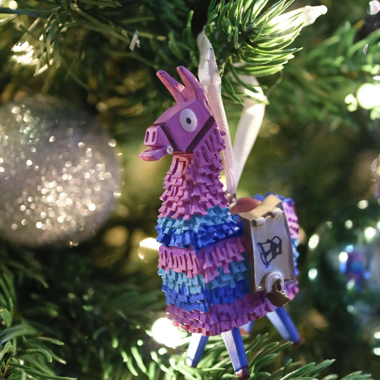 Fortnite loot llama ornament hanging on a Christmas tree