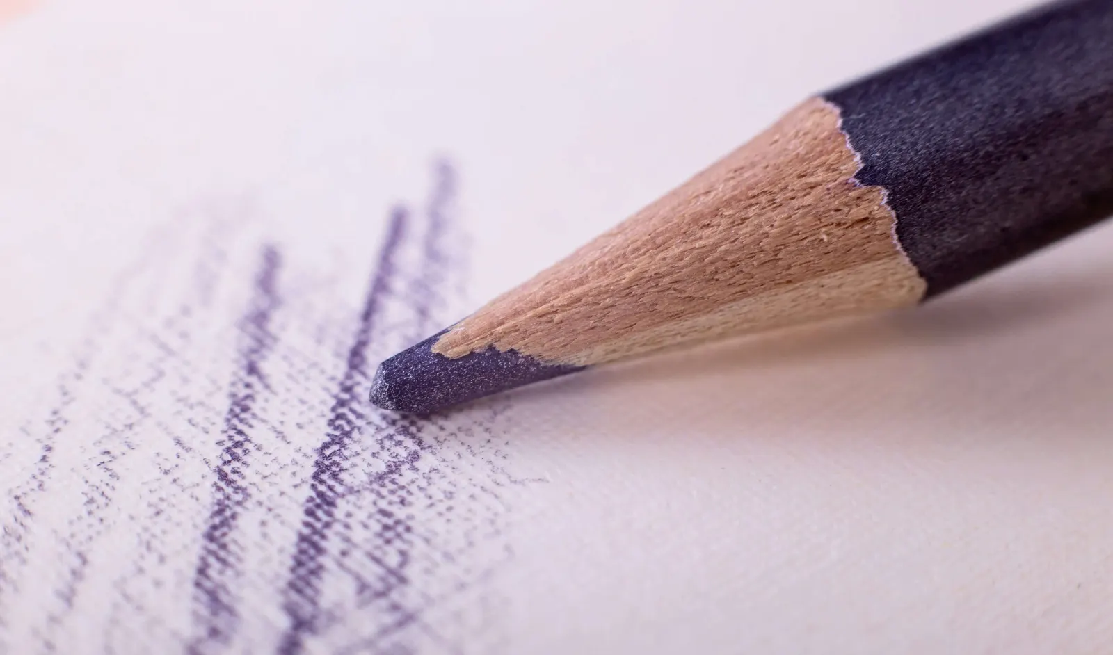 Extreme close-up of a blue colored pencil shading on paper