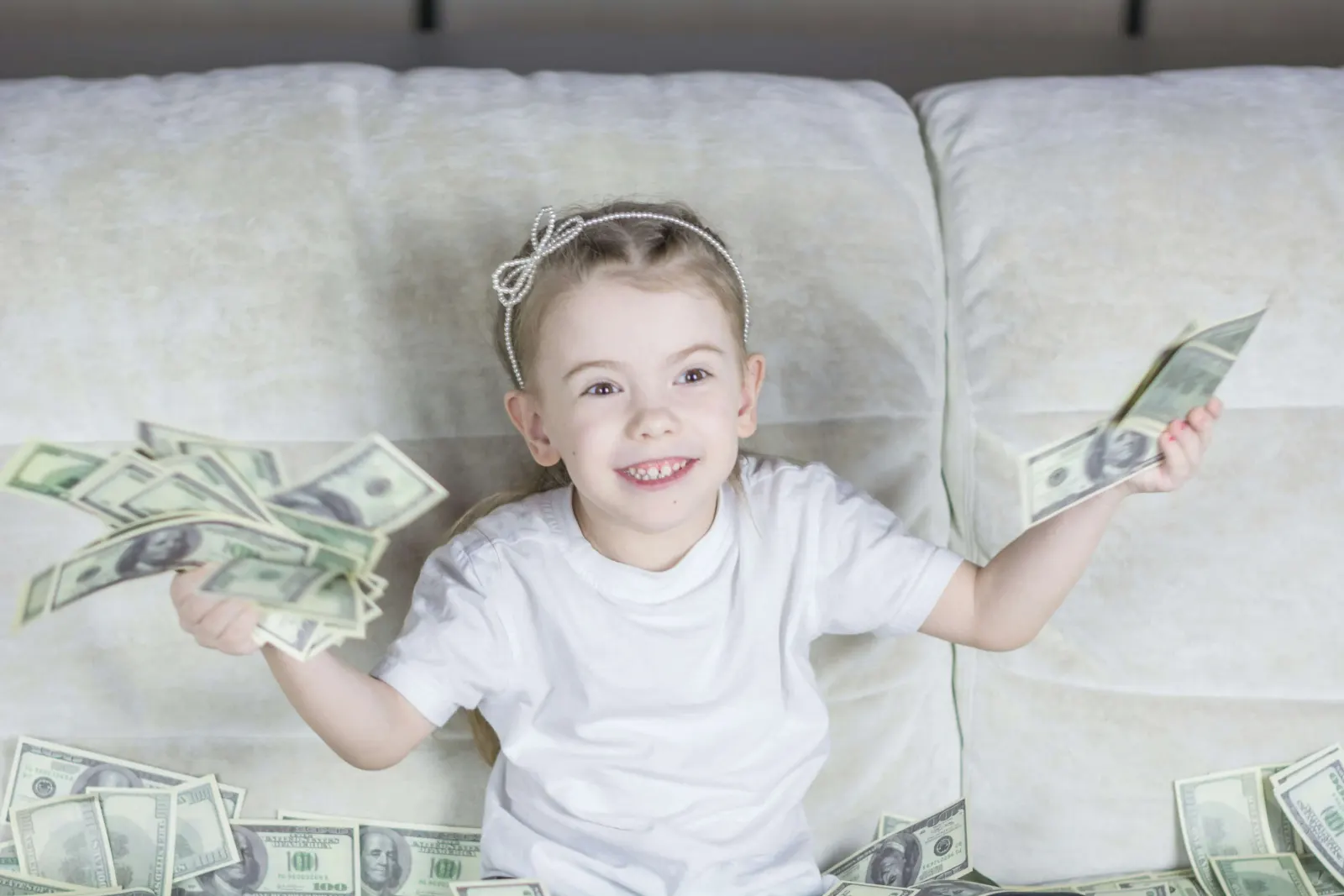 Little girl holds cash