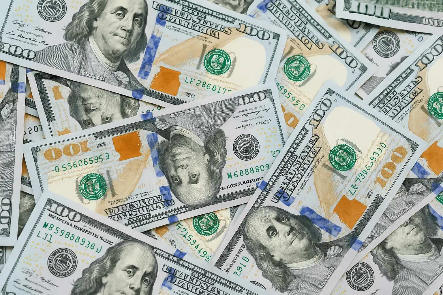 Close-up pile of scattered hundred-dollar bills