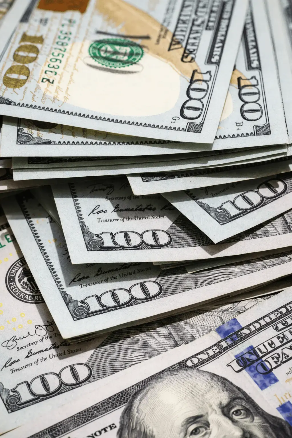 Close-up of a messy stack of folded hundred-dollar bills