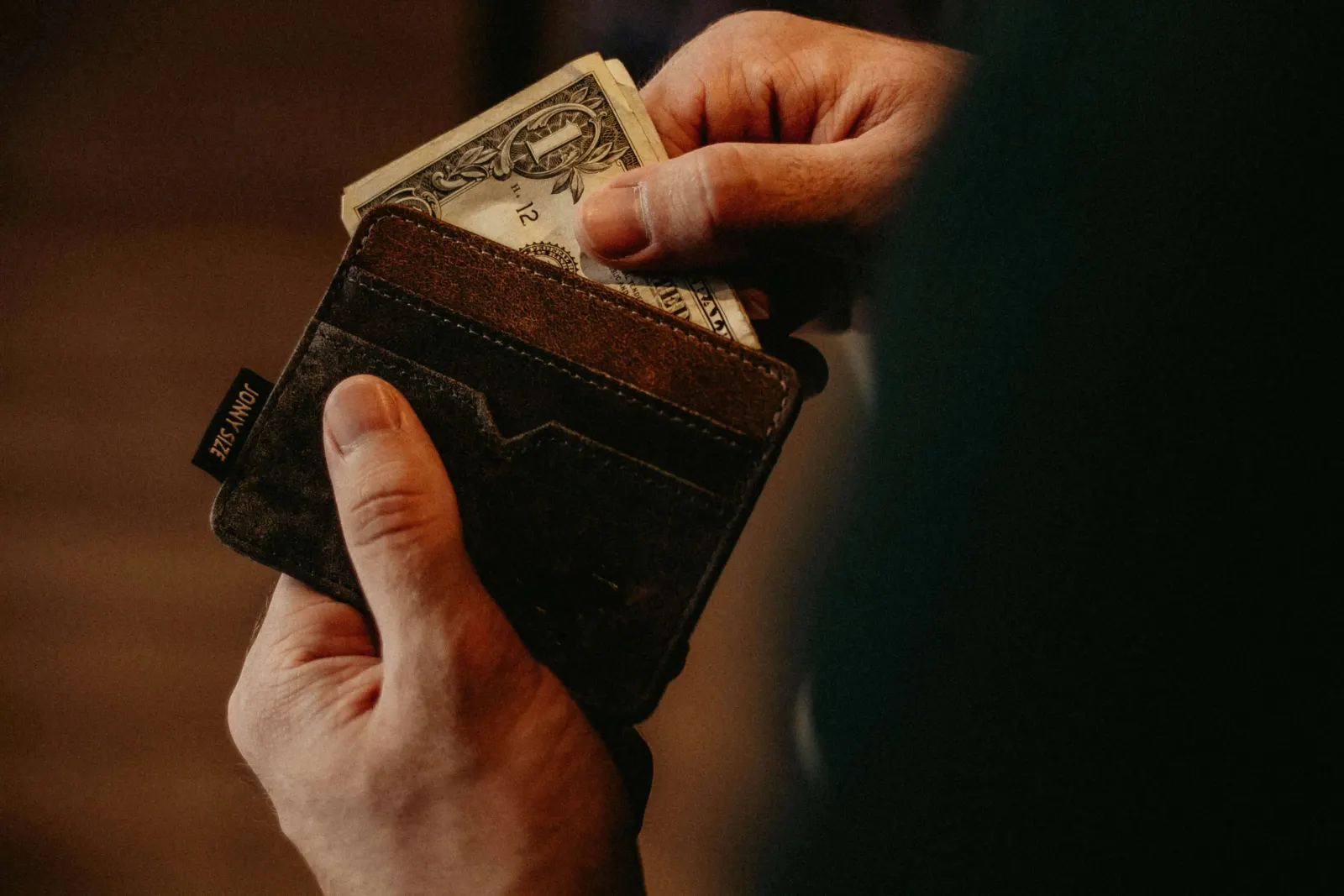 1 dollar bill in a leather wallet