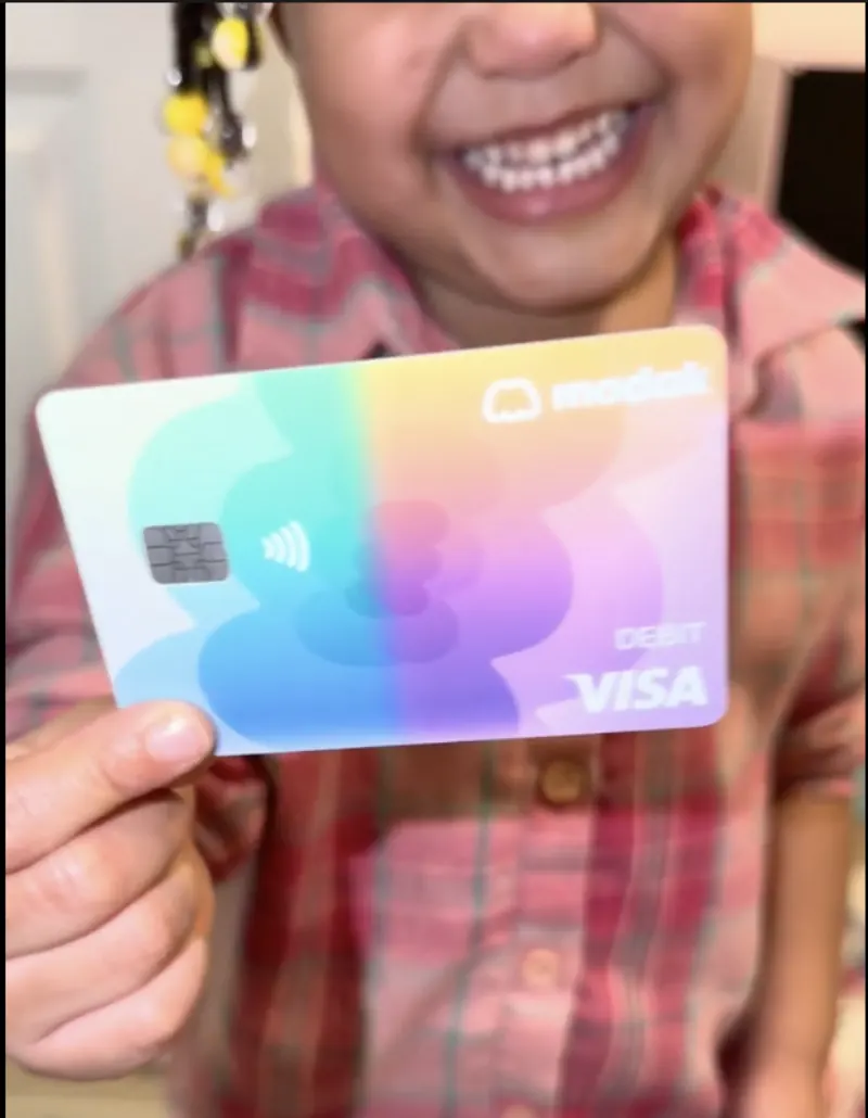 Modak family — kid with their card